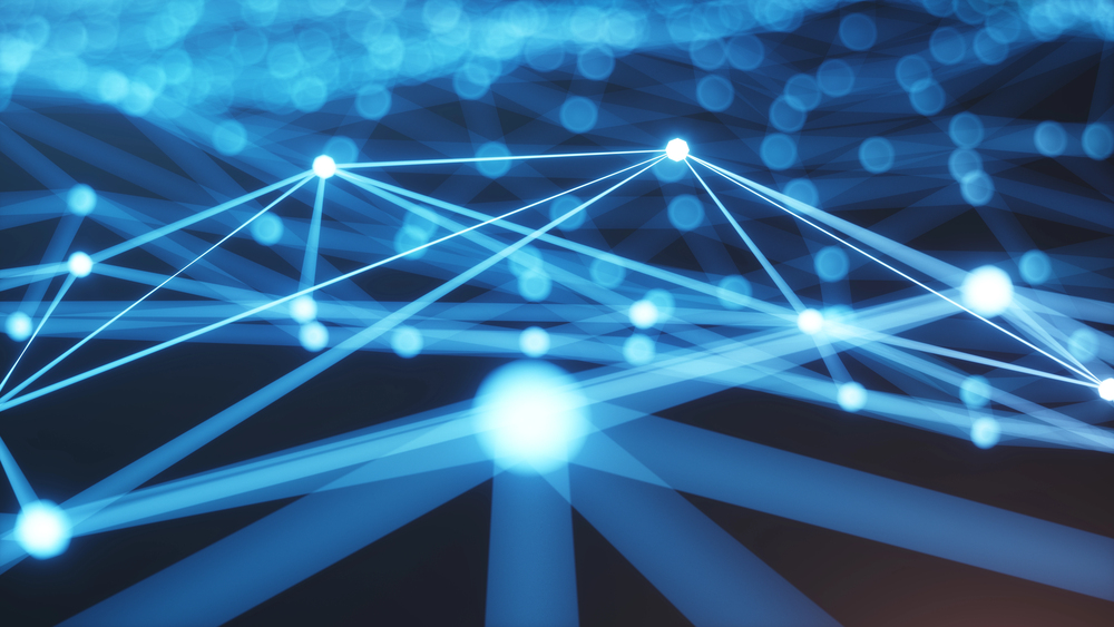 Abstract digital illustration of connected glowing blue nodes and lines, representing a network or data connections, on a dark background with blurred lights.